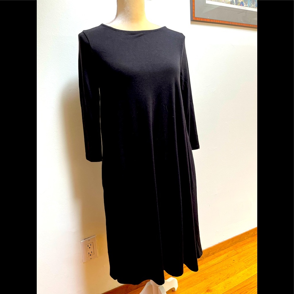 Black dress with jewel neckline and 3/4 sleeves.